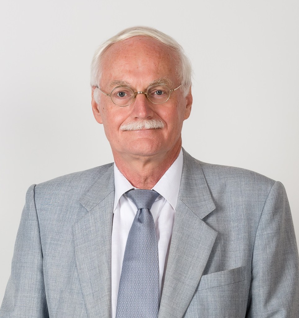 white haired man in a grey suit